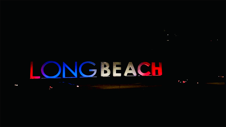 Long beach sign cars driving by slow motion
